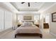 Comfortable main bedroom features neutral decor, tray ceiling, and ensuite access at 2851 Wilkes Lake Dr, Fuquay Varina, NC 27526