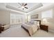 Serene main bedroom with tray ceilings, large windows, and soft, neutral decor at 2851 Wilkes Lake Dr, Fuquay Varina, NC 27526