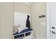 Mudroom with coat rack and blue cushioned bench over storage, next to the side door at 2851 Wilkes Lake Dr, Fuquay Varina, NC 27526