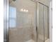 Shower with glass door and tiled walls, offering both style and functionality at 2851 Wilkes Lake Dr, Fuquay Varina, NC 27526