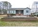 Backyard view with stone retaining wall and screened-in porch at 290 Silver Creek Dr, Clayton, NC 27520