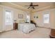 Bedroom with tray ceiling, ceiling fan, and bedside tables at 290 Silver Creek Dr, Clayton, NC 27520