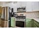 Stainless steel appliances complement the stylish kitchen with bright countertops and cabinets at 290 Silver Creek Dr, Clayton, NC 27520