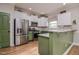 Well-lit kitchen features stainless appliances, updated granite countertops, and modern cabinetry at 290 Silver Creek Dr, Clayton, NC 27520