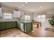 Charming kitchen with green cabinets, granite countertops, stainless appliances, and a dining nook at 290 Silver Creek Dr, Clayton, NC 27520