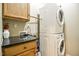 A laundry room featuring stacked washer and dryer, along with a granite countertop at 290 Silver Creek Dr, Clayton, NC 27520