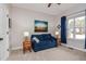 Cozy living room with a blue sofa, side tables with lamps, and a window at 290 Silver Creek Dr, Clayton, NC 27520