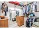 Walk-in closet with wooden drawers, shelving, and hanging rods for optimal storage at 290 Silver Creek Dr, Clayton, NC 27520