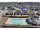 Aerial view of a community pool surrounded by homes, landscaping, and recreational facilities at 2907 Jakes View Pt, Fuquay Varina, NC 27526