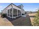 A spacious, fenced-in backyard with a screened porch, patio, and lush lawn, perfect for outdoor living at 2907 Jakes View Pt, Fuquay Varina, NC 27526