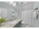 This bathroom features a granite countertop, tiled floors, and a shower with white tiling at 2907 Jakes View Pt, Fuquay Varina, NC 27526