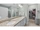 Bright bathroom with double vanity, granite counters, walk-in shower, and walk-in closet at 2907 Jakes View Pt, Fuquay Varina, NC 27526