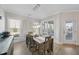 Dining room featuring a rustic wooden table, modern lighting, and large windows at 2907 Jakes View Pt, Fuquay Varina, NC 27526