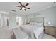 This main bedroom has carpet, a ceiling fan, and access to an ensuite bathroom and walk-in closet at 2907 Jakes View Pt, Fuquay Varina, NC 27526