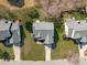 An aerial view shows a home with mature trees, a well manicured lawn, and a partially shaded deck at 3003 Cregler Dr, Apex, NC 27502
