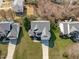 An aerial view shows a home with mature trees, a well manicured lawn, and driveway at 3003 Cregler Dr, Apex, NC 27502