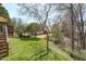 A beautifully landscaped backyard with mature trees and a gentle slope is great for outdoor living at 3003 Cregler Dr, Apex, NC 27502