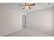 Bedroom with neutral carpet and walls, features a ceiling fan and closet at 3003 Cregler Dr, Apex, NC 27502