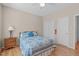 Comfortable bedroom with a ceiling fan, a patterned bedspread, and a window at 3003 Cregler Dr, Apex, NC 27502
