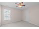 Bright bedroom featuring a ceiling fan and a window letting in natural light at 3003 Cregler Dr, Apex, NC 27502