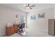 Guest bedroom offers neutral walls, carpeted floor and ceiling fan, and office furniture and storage cabinets at 3003 Cregler Dr, Apex, NC 27502
