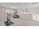 Spacious bonus room with exercise bike, cozy armchair, and natural light at 3003 Cregler Dr, Apex, NC 27502