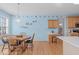 Bright breakfast nook with light blue walls, wood floors, and a round table next to a window at 3003 Cregler Dr, Apex, NC 27502