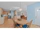 Dining area with hardwood floors, table with blue chairs, and lots of natural light at 3003 Cregler Dr, Apex, NC 27502