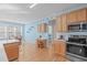 Eat-in kitchen with hardwood floors, stainless steel appliances, and a cozy dining area at 3003 Cregler Dr, Apex, NC 27502