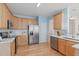 Well-equipped kitchen with stainless steel appliances, light wood cabinetry, and ample counter space at 3003 Cregler Dr, Apex, NC 27502