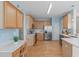 Bright kitchen with stainless steel appliances, light wood cabinets, and hardwood flooring at 3003 Cregler Dr, Apex, NC 27502