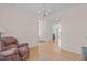 Spacious living room leading to other rooms, with hardwood flooring and a recliner at 3003 Cregler Dr, Apex, NC 27502