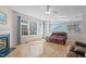 Bright and airy living room featuring hardwood floors, large windows, and a cozy fireplace at 3003 Cregler Dr, Apex, NC 27502