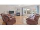 Comfortable living room with hardwood floors, fireplace, and large windows showcasing the backyard at 3003 Cregler Dr, Apex, NC 27502