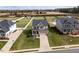 An aerial view of a two-story home with a manicured lawn and a paved driveway, nestled in a suburban neighborhood at 319 Brinkley Cir, Mebane, NC 27302