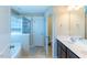 Bright bathroom featuring a soaking tub, glass enclosed shower, and dual sink vanity at 319 Brinkley Cir, Mebane, NC 27302