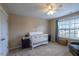 Serene bedroom with a white crib, soft lighting, and a large window, creating a peaceful Bedroom environment at 319 Brinkley Cir, Mebane, NC 27302