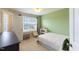 Bright bedroom with green walls, a bed, and a window with neighborhood views at 319 Brinkley Cir, Mebane, NC 27302
