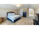 Spacious carpeted bedroom with a ceiling fan and a comfortable bed with a blue patterned bedspread at 319 Brinkley Cir, Mebane, NC 27302