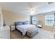 A bedroom featuring natural light from two windows, a ceiling fan, and a bed with storage bench at 319 Brinkley Cir, Mebane, NC 27302