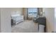Charming Bedroom featuring a white crib, changing table, and a comfortable armchair by the window at 319 Brinkley Cir, Mebane, NC 27302