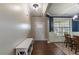 Entryway next to a naturally lit dining area, featuring dark hardwood floors and white wainscoting at 319 Brinkley Cir, Mebane, NC 27302