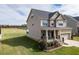 An exterior view of a two-story home with a cozy front porch and a well-maintained lawn at 319 Brinkley Cir, Mebane, NC 27302