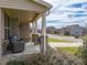 Charming brick front porch with comfortable seating and views of the neighborhood street at 319 Brinkley Cir, Mebane, NC 27302