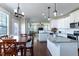 Bright open kitchen featuring stainless steel appliances, granite countertops, and an island with a view into the living room at 319 Brinkley Cir, Mebane, NC 27302