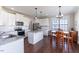 A bright kitchen featuring white cabinets, stainless steel appliances, and a breakfast nook area at 319 Brinkley Cir, Mebane, NC 27302