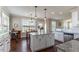 Eat-in kitchen featuring a center island with granite countertop, stainless steel appliances, and a modern design at 319 Brinkley Cir, Mebane, NC 27302