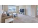 Inviting living room with neutral tones, plush carpet, and large windows, creating a relaxing space at 319 Brinkley Cir, Mebane, NC 27302
