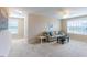 Spacious living room with two windows, neutral walls, plush carpeting and comfortable seating area at 319 Brinkley Cir, Mebane, NC 27302