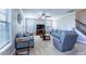 Bright and airy living room featuring multiple windows, plush seating, and a ceiling fan at 319 Brinkley Cir, Mebane, NC 27302